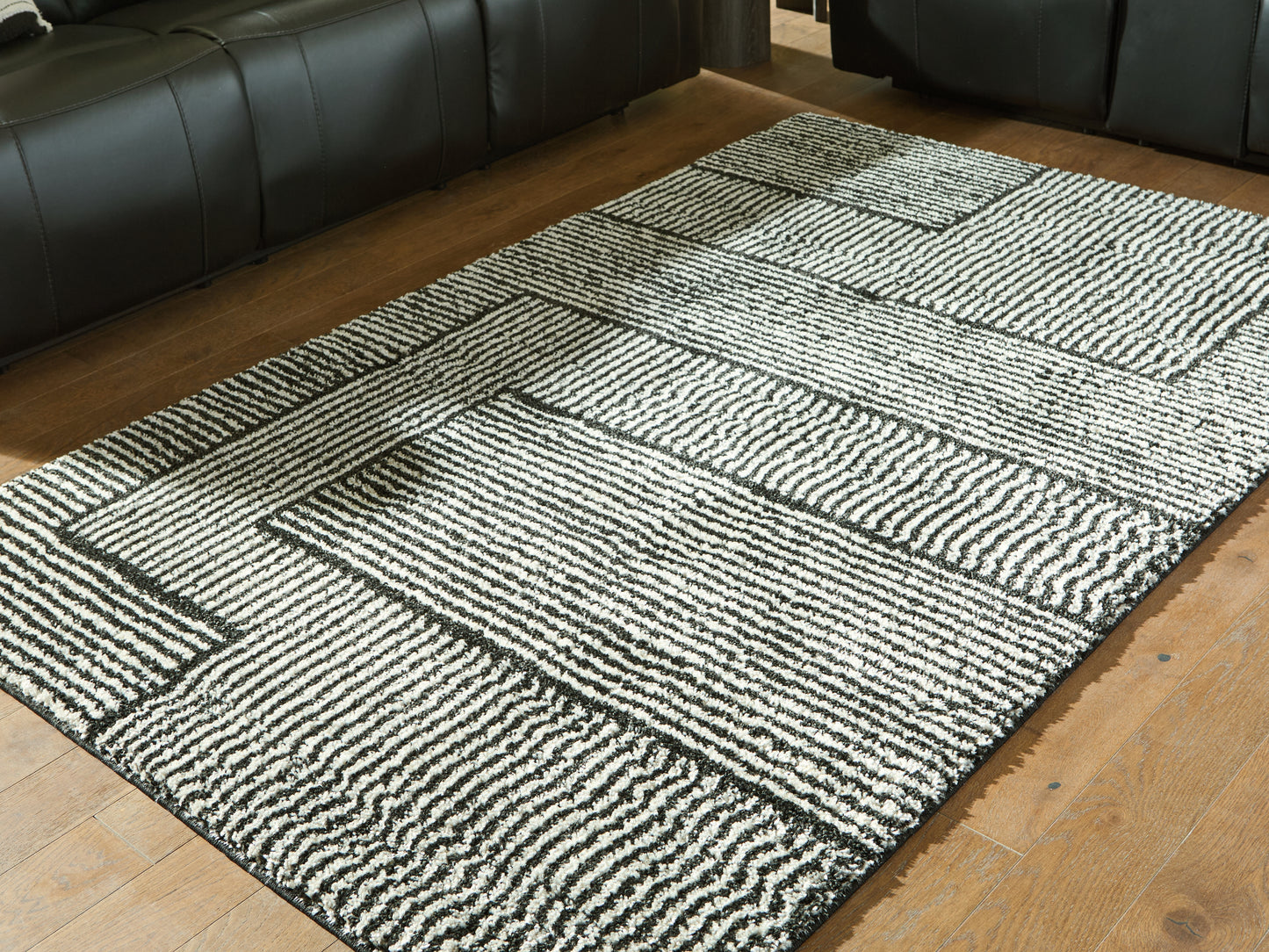 The Furniture Outlets - Ashley Furniture - Kurtmen Rug - 5' x 7' Area Rug / Black/Ivory - R407592