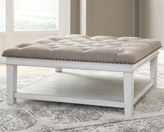 The Furniture Outlets - Ashley Furniture - Kanwyn Upholstered Ottoman Coffee Table - UPH Ottoman Cocktail Table / Whitewash - T937-21