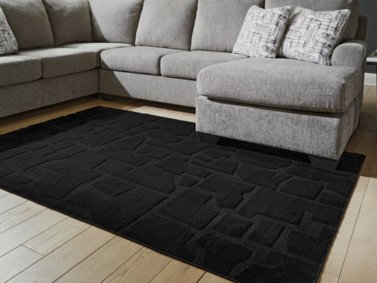 The Furniture Outlets - Ashley Furniture - Gibbswell Rug - Washable 5' x 7' Area Rug / Black - R407462